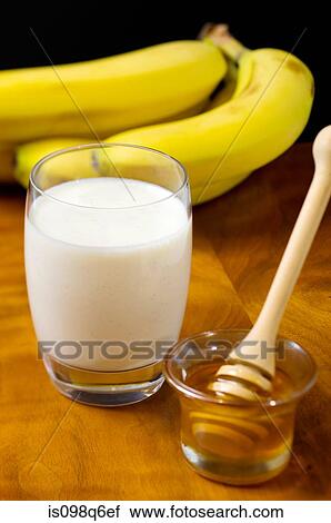 Glass of milk banana and honey View Large Photo Image Stock Image - Glass of milk banana and honey. Fotosearch