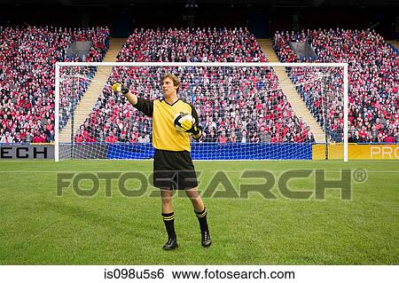 Goalkeeper holding football View Large Photo Image Stock Photograph - Goalkeeper holding football. Fotosearch