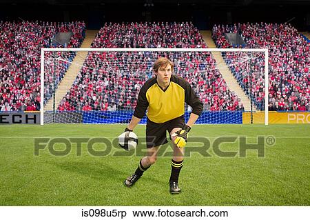 Goalkeeper throwing football View Large Photo Image Stock Photography - Goalkeeper throwing football. Fotosearch