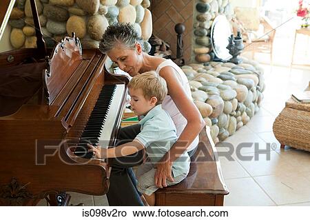 Grandmother and grandson playing the piano View Large Photo Image Picture - Grandmother and grandson playing the piano. Fotosearch