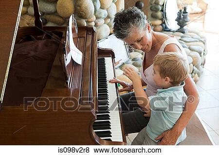 Stock Photo - Grandmother and grandson playing the piano. Fotosearch
