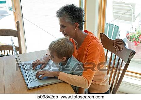 Grandmother and grandson using laptop View Large Photo Image Stock Photography - Grandmother and grandson using laptop. Fotosearch
