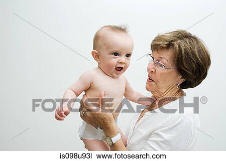 Stock Image - Grandmother holding baby grandson. Fotosearch