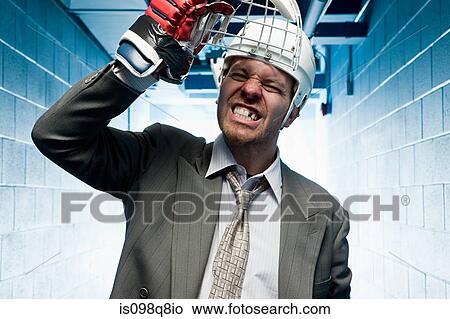 Grimacing businessman in a sports helmet View Large Photo Image Picture - Grimacing businessman in a sports helmet. Fotosearch