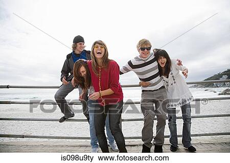 Group of friends laughing at beach View Large Photo Image Stock Photo - Group of friends laughing at beach. Fotosearch