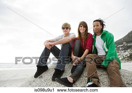 Group of friends sitting on boulder View Large Photo Image Stock Image - Group of friends sitting on boulder. Fotosearch
