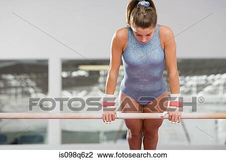Gymnast on an uneven parallel bar View Large Photo Image Stock Image - Gymnast on an uneven parallel bar. Fotosearch