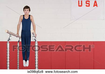 Stock Photo - Gymnast on parallel bars. Fotosearch