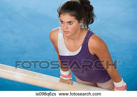 Gymnast on uneven parallel bars View Large Photo Image Stock Photograph - Gymnast on uneven parallel bars. Fotosearch