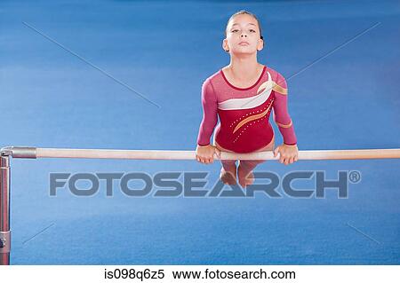 Stock Photography - Gymnast on unparallel bars. Fotosearch