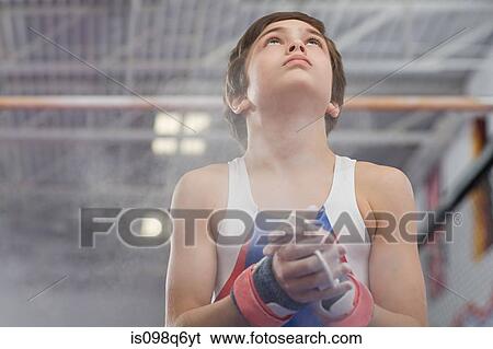 Gymnast rubbing sports chalk onto his hands View Large Photo Image Stock Photograph - Gymnast rubbing sports chalk onto his hands. Fotosearch