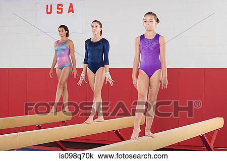 Gymnasts on a balance beam View Large Photo Image Stock Image - Gymnasts on a balance beam. Fotosearch
