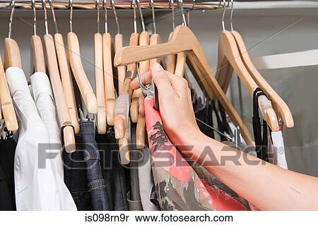 Hand of a woman and clothing rail View Large Photo Image Stock Photography - Hand of a woman and clothing rail. Fotosearch