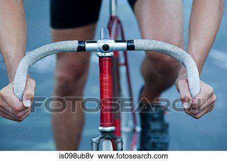 Stock Photo - Hands of cyclist and handlebars. Fotosearch