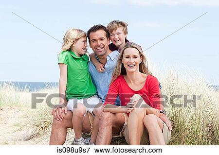 Happy family at the coast View Large Photo Image Stock Photo - Happy family at the coast. Fotosearch