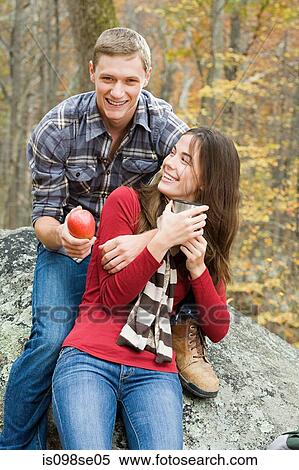 Stock Photography - Happy young couple in forest. Fotosearch