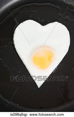 Heart shaped fried egg View Large Photo Image Stock Photography - Heart shaped fried egg. Fotosearch