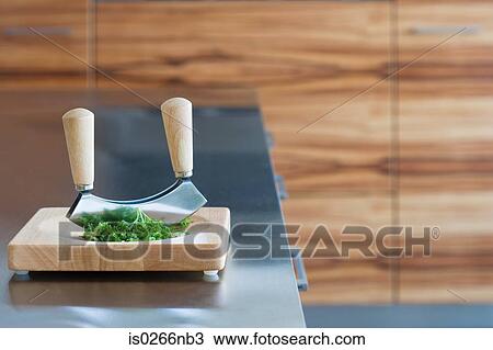 Herb cutter and herbs on a chopping board View Large Photo Image Stock Image - Herb cutter and herbs on a chopping board. Fotosearch