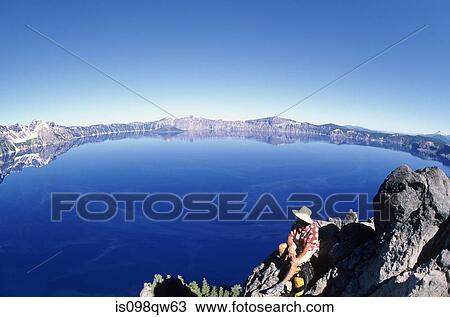 Hiker by crater lake View Large Photo Image Stock Image - Hiker by crater lake. Fotosearch