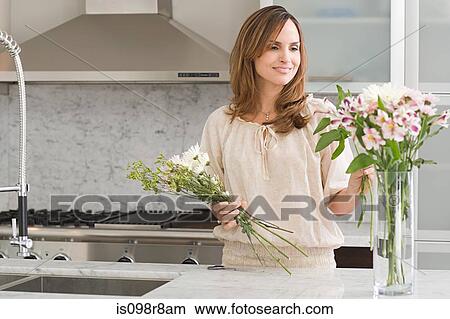 Picture - Hispanic woman flower arranging. Fotosearch