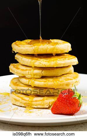 Honey pouring over pancakes View Large Photo Image Stock Image - Honey pouring over pancakes. Fotosearch