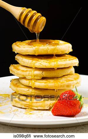Honey pouring over pancakes View Large Photo Image Stock Image - Honey pouring over pancakes. Fotosearch
