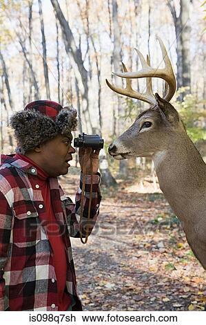 Hunter face to face with a deer View Large Photo Image Stock Image - Hunter face to face with a deer. Fotosearch