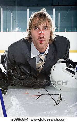Injured businessman playing ice hockey View Large Photo Image Picture - Injured businessman playing ice hockey. Fotosearch