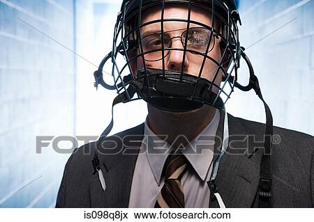 Injured businessman wearing an ice hockey helmet View Large Photo Image Stock Photo - Injured businessman wearing an ice hockey helmet. Fotosearch