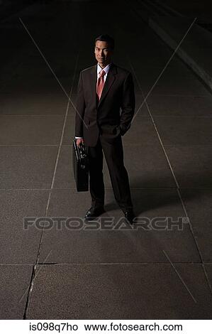 Japanese businessman on a sidewalk at night View Large Photo Image Picture - Japanese businessman on a sidewalk at night. Fotosearch