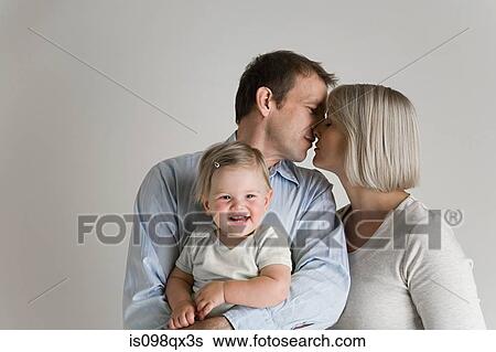 Stock Photograph - Kissing couple with baby. Fotosearch