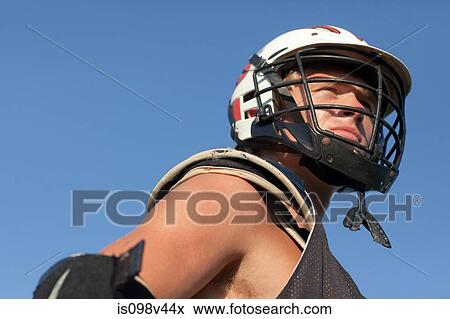 Lacrosse player wearing helmet View Large Photo Image Stock Photo - Lacrosse player wearing helmet. Fotosearch