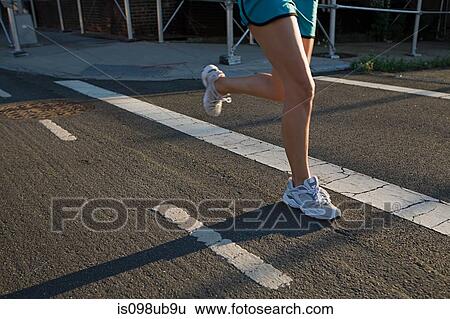 Legs of runner on road View Large Photo Image Stock Photograph - Legs of runner on road. Fotosearch