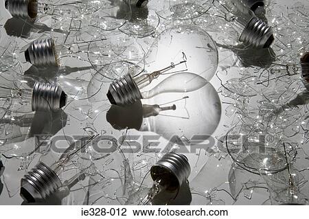Stock Image - Lightbulb surrounded by broken bulbs. Fotosearch