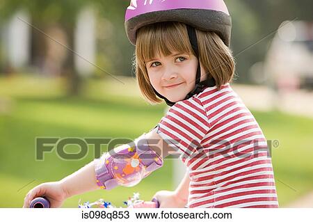 Little girl on a bicycle View Large Photo Image Stock Image - Little girl on a bicycle. Fotosearch
