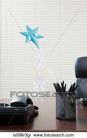 Magic wand sticking out of pen holder on office desk View Large Photo Image Stock Photography - Magic wand sticking out of pen holder on office desk. Fotosearch