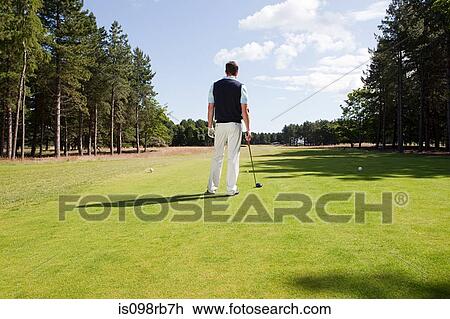 Stock Image - Male golfer on the fairway. Fotosearch