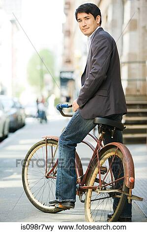 Male office worker on a bicycle View Large Photo Image Stock Photo - Male office worker on a bicycle. Fotosearch