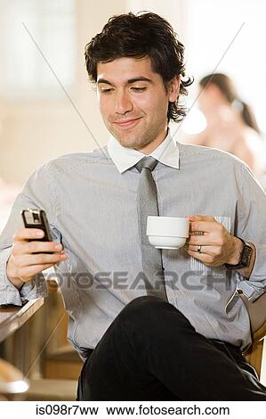 Male office worker text messaging View Large Photo Image Stock Photo - Male office worker text messaging. Fotosearch