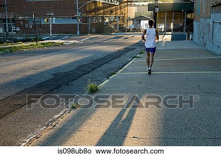 Male runner on urban street View Large Photo Image Picture - Male runner on urban street. Fotosearch