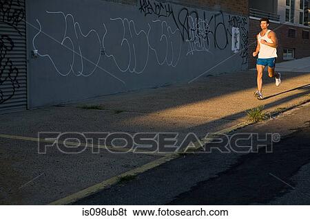 Stock Photograph - Male runner on urban street. Fotosearch