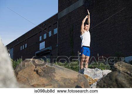 Stock Image - Male runner stretching. Fotosearch