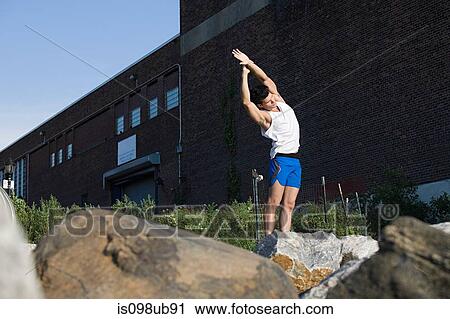 Male runner stretching View Large Photo Image Stock Image - Male runner stretching. Fotosearch