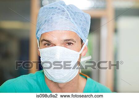 Stock Image - Male surgeon wearing mask and cap. Fotosearch