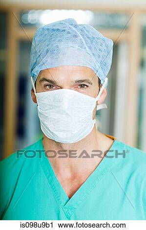 Stock Image - Male surgeon wearing mask and cap. Fotosearch