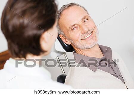 Picture - Man and dentist. Fotosearch