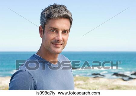 Stock Photo - Man at the coast. Fotosearch