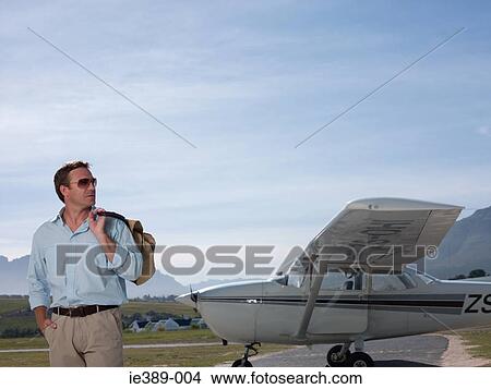 Man by private aeroplane View Large Photo Image Picture - Man by private aeroplane. Fotosearch