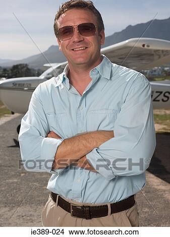 Picture - Man by private aeroplane. Fotosearch