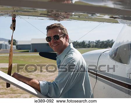 Stock Image - Man by private aeroplane. Fotosearch